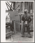 Gold miner waiting for cage to be lowered underground, Mogollon, New Mexico