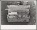 Box containing samples of milled tailing solutions which are sent to Silver City, New Mexico, for analysis, Mogollon, New Mexico