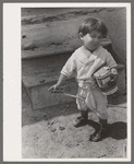 Spanish-American boy playing horse, Chamisal, New Mexico