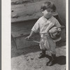 Spanish-American boy playing horse, Chamisal, New Mexico