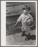 Spanish-American boy playing horse, Chamisal, New Mexico