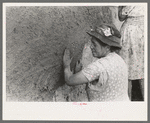 After plaster is applied with towel it is smoothed out with the hands. The women pride themselves on careful plastering, Chamisal, New Mexico