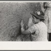 After plaster is applied with towel it is smoothed out with the hands. The women pride themselves on careful plastering, Chamisal, New Mexico