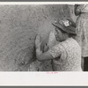 After plaster is applied with towel it is smoothed out with the hands. The women pride themselves on careful plastering, Chamisal, New Mexico