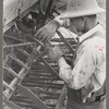 Mormon farmer working on FSA (Farm Security Administration) cooperative drill, Oneida County, Idaho. While the members of the cooperative live in Snowville, Utah, some of them farm in Oneida County, Idaho