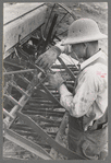 Mormon farmer working on FSA (Farm Security Administration) cooperative drill, Oneida County, Idaho. While the members of the cooperative live in Snowville, Utah, some of them farm in Oneida County, Idaho