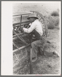 Mormon farmer working on FSA (Farm Security Administration) cooperative drill, Oneida County, Idaho. While the members of the cooperative live in Snowville, Utah, some of them farm in Oneida County, Idaho