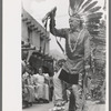 A member of the Forest Service who is participating in Indian dances at the fiesta, Taos, New Mexico