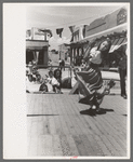 Spanish-American girl in native dance. Fiesta at Taos, New Mexico
