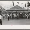 Old merry-go-round at Taos, New Mexico, during fiesta. This is reputed to be the oldest merry-go-round in America