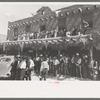 Crowds lined the streets and stood on top of covered sidewalks to see the dances at the fiesta, Taos, New Mexico