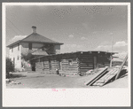 Delta County, Colorado. Home and old log cabin on a peach grower's farm. This man came from Oklahoma determined never again to dry land farm; his peaches are irrigated. He was fortunate in finding a place to rent from a farmer who was very old and wanted