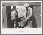 Loading gold ore concentrate into freight cars of narrow gauge railroad, Ouray, Colorado