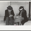 Farmer and his wife write a letter on the post office steps, Ontario, Oregon