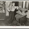 J. A. Fisher, storekeeper, postmaster and depot agent of Funkley, Minnesota, by stove of his own creation.  Funkley is rapidly becoming a "ghost town."