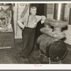 J. A. Fisher, storekeeper, postmaster and depot agent of Funkley, Minnesota, by stove of his own creation.  Funkley is rapidly becoming a "ghost town."