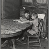 Children of Frank Weeks looking through a catalogue