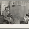 Mrs. H. Gerling and baby in living room in farmhouse near Wheelock, North Dakota