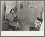 Mrs. H. Gerling and baby in living room in farmhouse near Wheelock, North Dakota