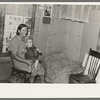 Mrs. H. Gerling and baby in living room in farmhouse near Wheelock, North Dakota