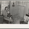 Mrs. H. Gerling and baby in living room in farmhouse near Wheelock, North Dakota