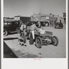 Loading supplies into farmer's wagon, Littlefork, Minnesota