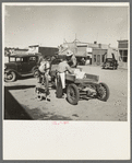 Loading supplies into farmer's wagon, Littlefork, Minnesota