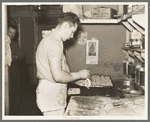 Camp cook making rolls. Logging camp near Effie, Minnesota