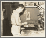 Camp cook making rolls. Logging camp near Effie, Minnesota