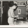 Camp cook making rolls. Logging camp near Effie, Minnesota