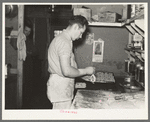 Camp cook making rolls. Logging camp near Effie, Minnesota