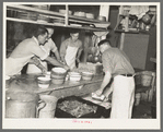 Dishing out and serving food in logging camp near Effie, Minnesota