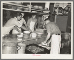 Dishing out and serving food in logging camp near Effie, Minnesota