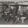 Lumberjacks in their bunkhouse after dinner. Logging camp near Effie, Minnesota