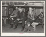 Lumberjacks in their bunkhouse after dinner. Logging camp near Effie, Minnesota