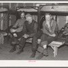 Lumberjacks in their bunkhouse after dinner. Logging camp near Effie, Minnesota