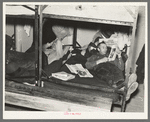 Lumberjacks resting in bunkhouse at logging camp near Effie, Minnesota