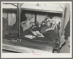 Lumberjacks resting in bunkhouse at logging camp near Effie, Minnesota