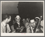 Two Cajun musicians with Mr. Wilson, Secretary of the National Rice Festival Association standing between them