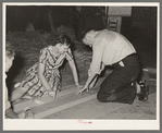 Cutting strips of colored paper to use in decorating float, National Rice Festival, Crowley, Louisiana