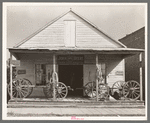 Wagons on porch of farm implements dealer. Erath, Louisiana