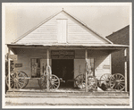 Wagons on porch of farm implements dealer. Erath, Louisiana