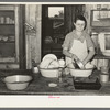 Mrs. M. LaBlanc washing dishes in kitchen of her present home. Morganza, Louisiana