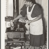 Farmer's wife cooking meat preparatory to canning. Lakeview Project, Arkansas