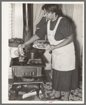 Farmer's wife cooking meat preparatory to canning. Lakeview Project, Arkansas