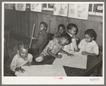 Negro children playing with chalk in nursery school. Lakeview Project, Arkansas