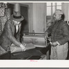 Storekeeper wrapping up package for farmer. Lakeview Project, Arkansas