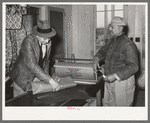 Storekeeper wrapping up package for farmer. Lakeview Project, Arkansas