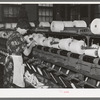 Worker winding cotton thread onto large spools. Laurel cotton mills, Laurel, Mississippi