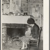 Wife and daughter of FSA client in front of fireplace of temporary home. Transylvania, Louisiana